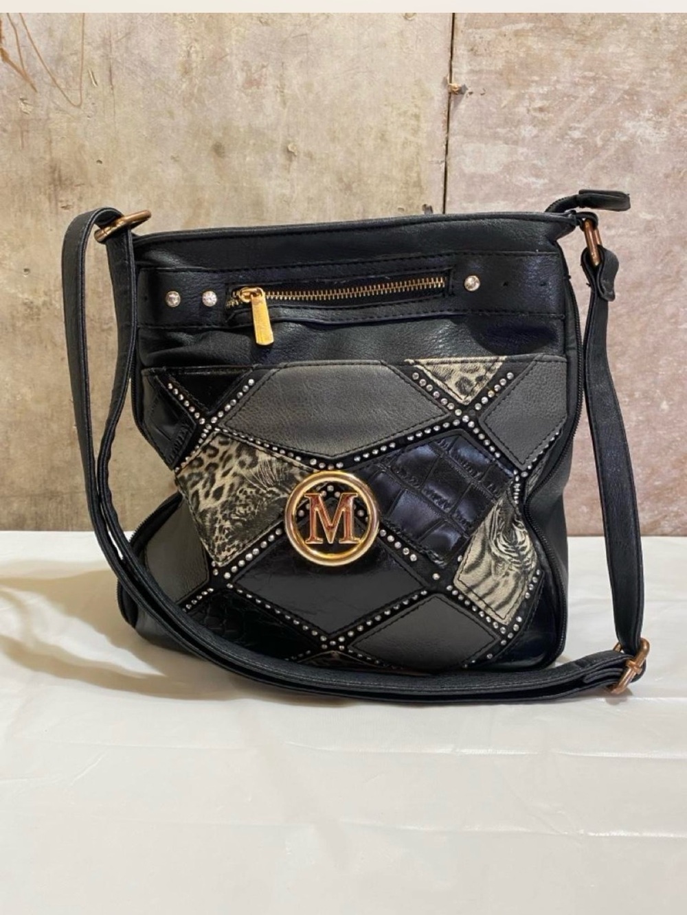 Black Patchwork Crossbody Bag with Gold 'M' Emblem